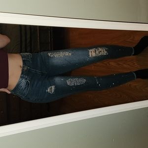 Faded, ripped and paint splattered skinny jeans